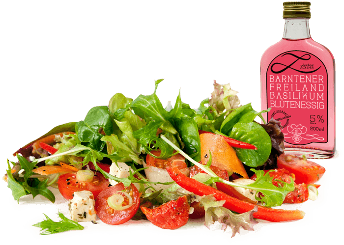 Foto von buntem Salat mit Basilikum-Blüten-Essig-Flasche